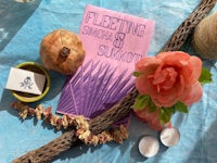 a book with flowers and a twig on a table